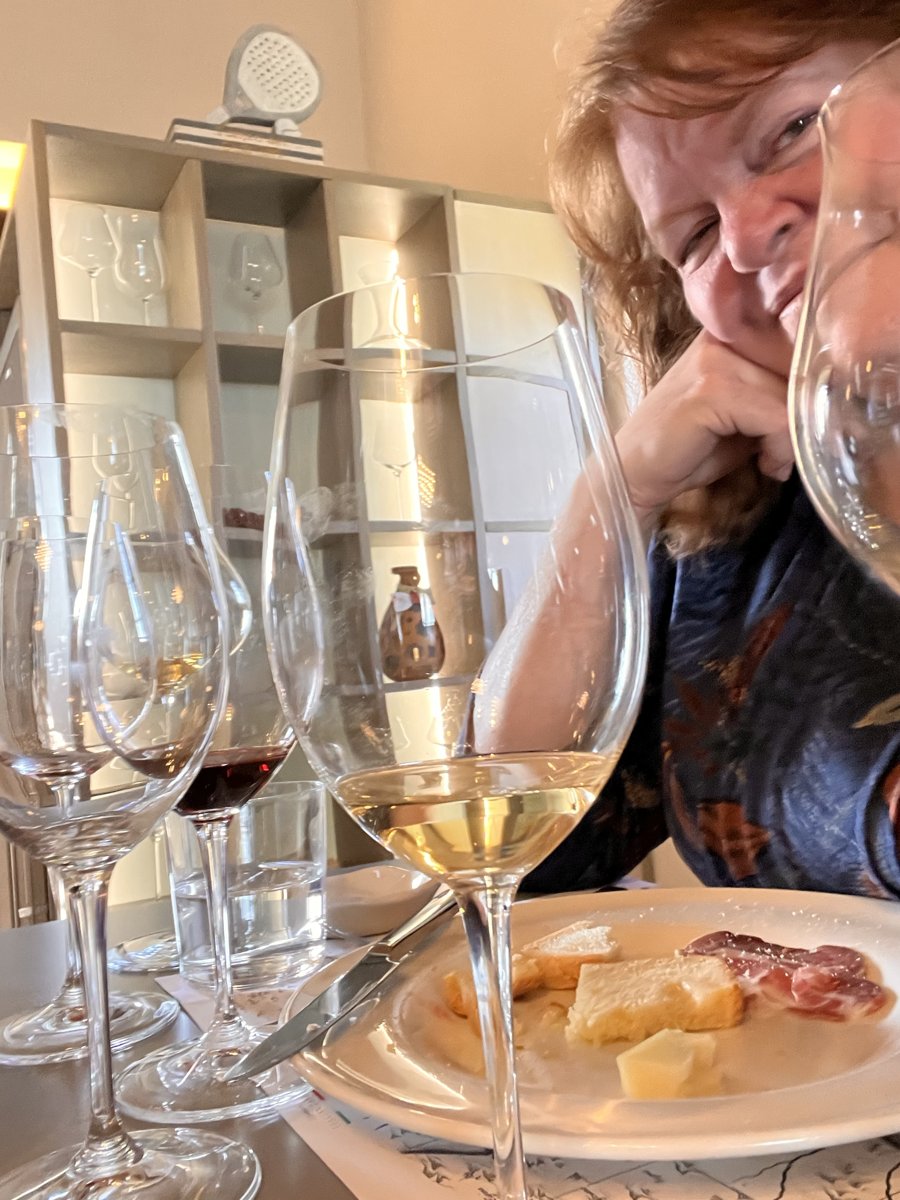 Sandee behind a row of wine glasses at Cantine Neri, Orvieto